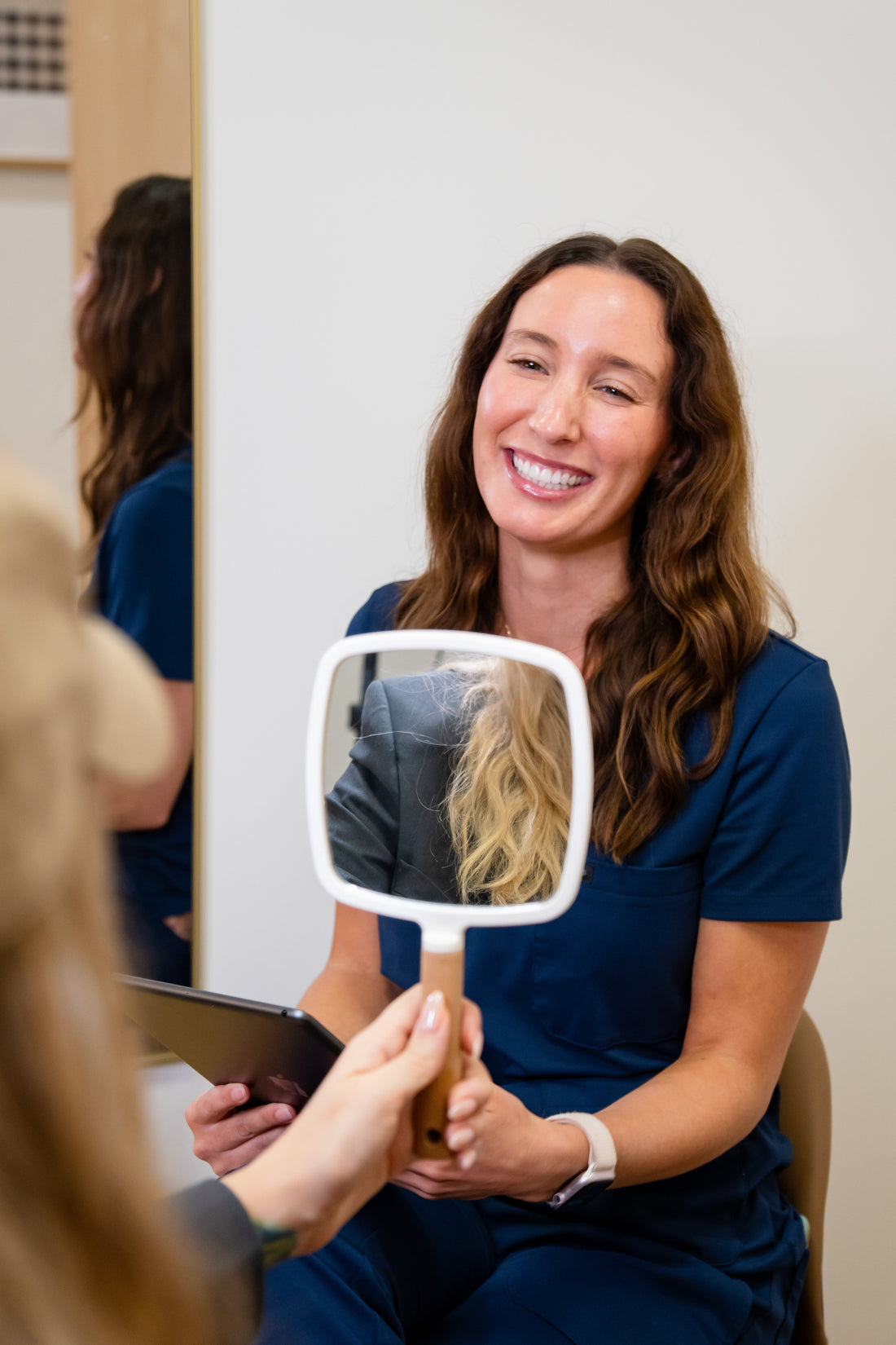 A med-spa provider guiding a client through a medical-grade skincare consultation in Plano, TX.